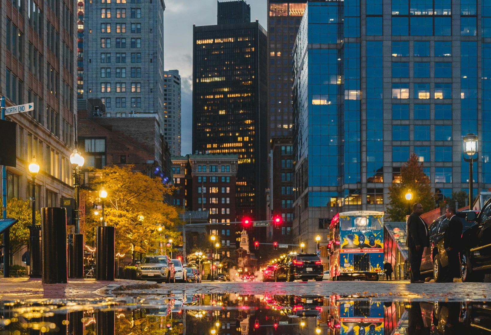 Cars driving on Boston streets near 100 Clarendon Street parking garage and AVIS Car Rental in Back Bay